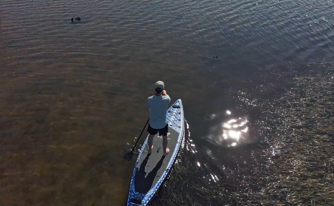 Aerial drone view of the Seeker touring board on a calm lake.
