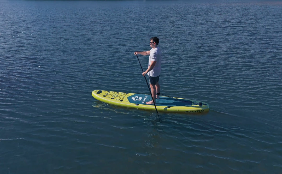 Drone shot of the Trekker 10'4" on a lake, emphasizing its compact shape.