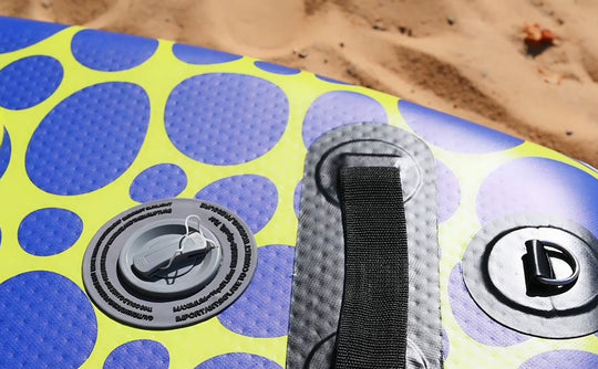 Close-up of the Trekker's traction pad and handle on the sand, showing the high-quality non-slip surface.