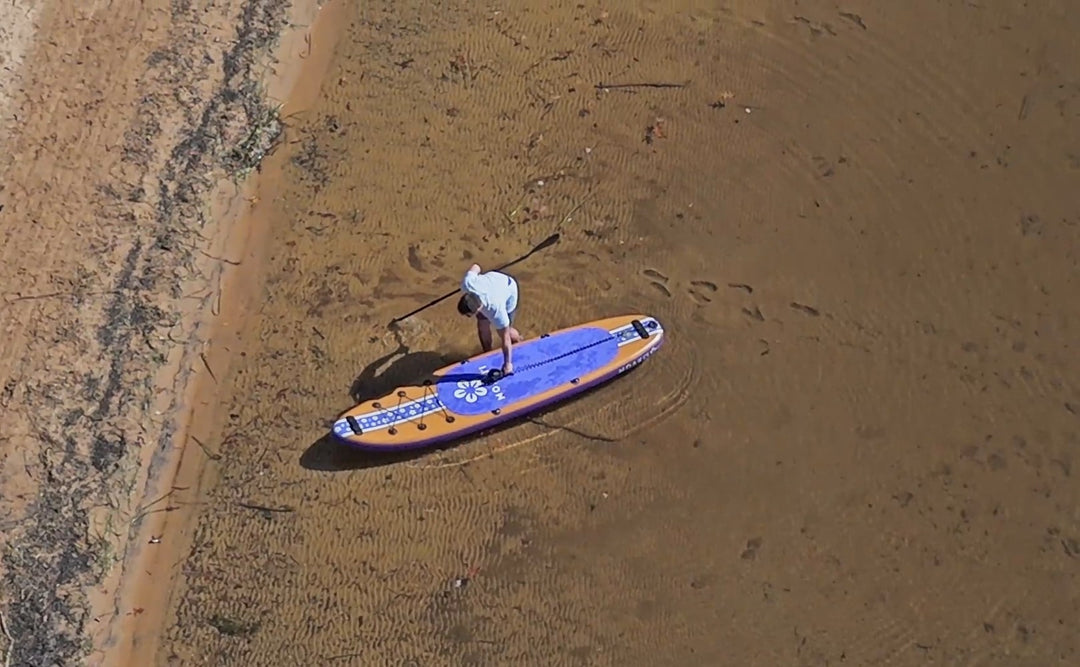 High-angle shot of a lone paddler on the Pathfinder, emphasizing its versatility for lake and river exploration.