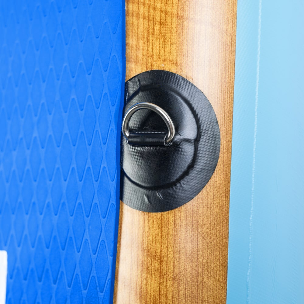 Close-up of the heavy-duty stainless steel D-ring and accessory mount on the Moaki'i Kiva traction pad.