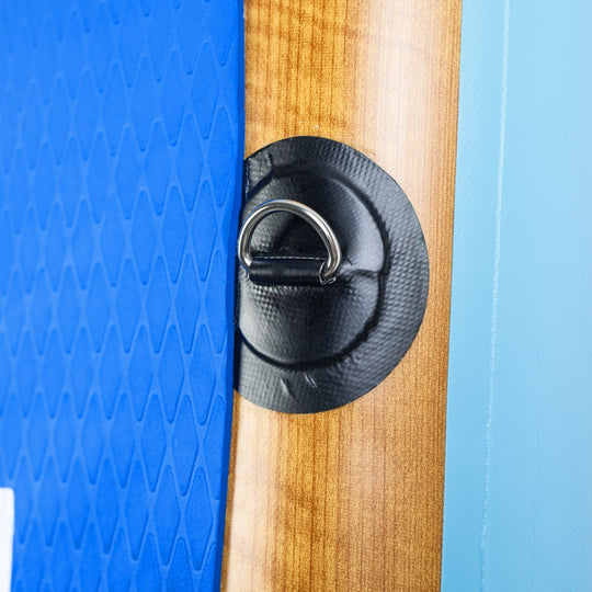 Close-up of the heavy-duty stainless steel D-ring and accessory mount on the Moaki'i Kiva traction pad.