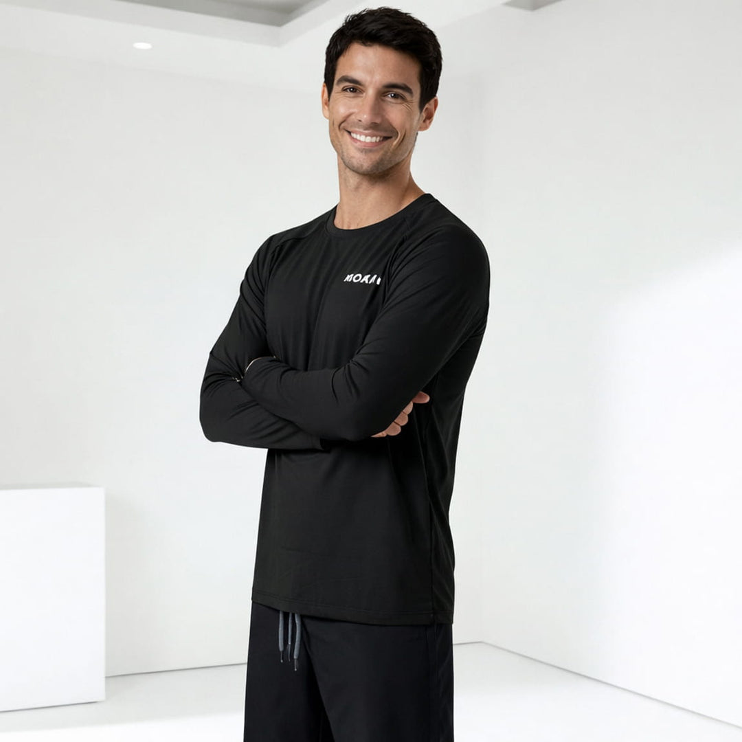 Man wearing a black rashguard with a logo on a white background