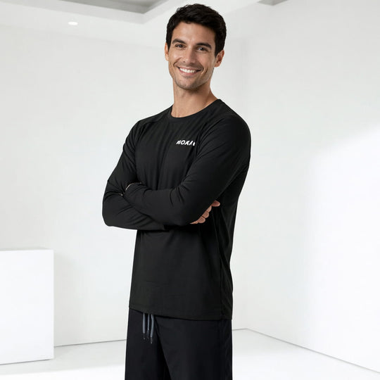 Man wearing a black rashguard with a logo on a white background
