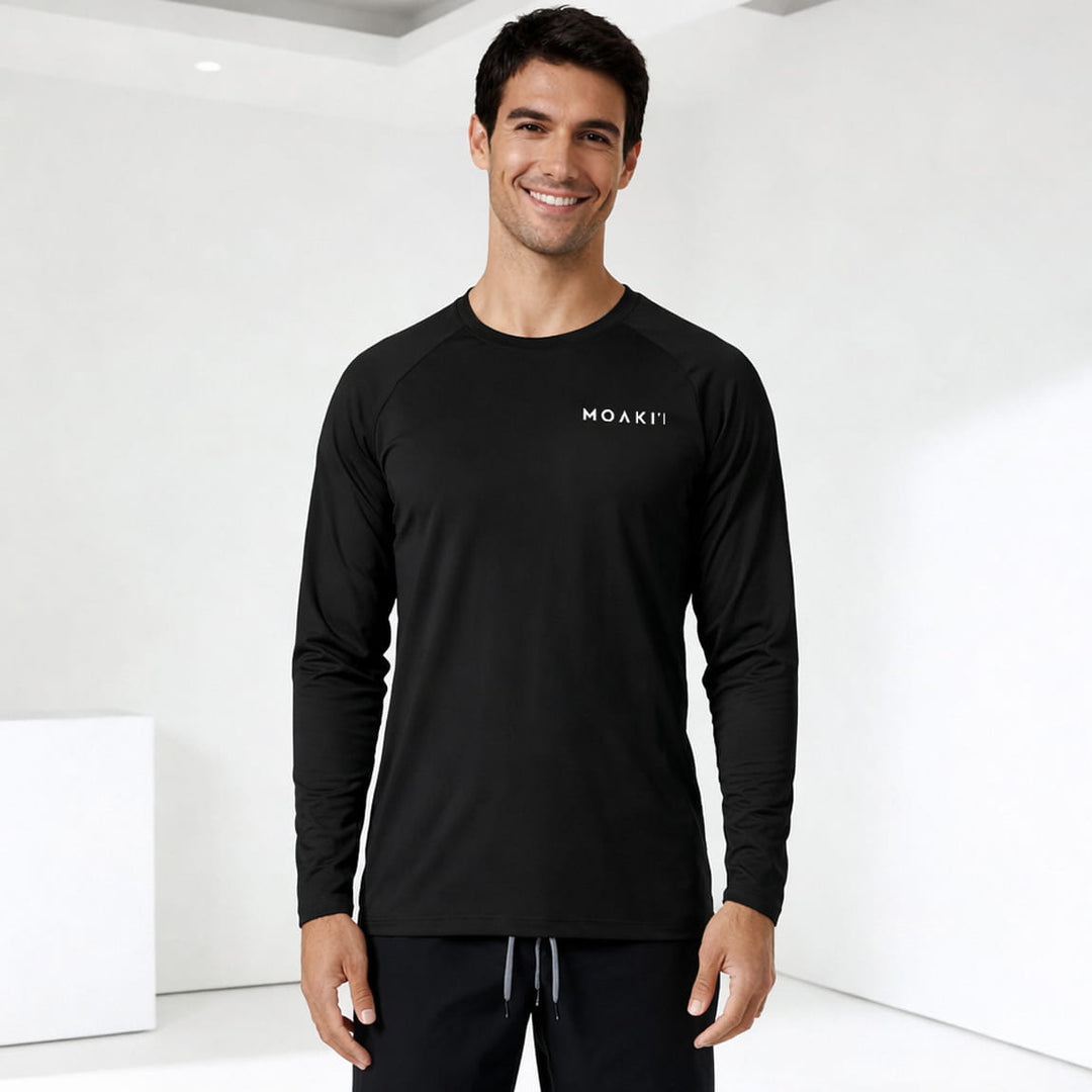 Man wearing a black long-sleeve shirt with a logo on a white background