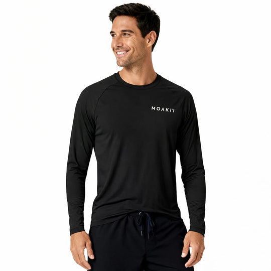 Man wearing a black long-sleeve athletic shirt with a brand logo on a white background
