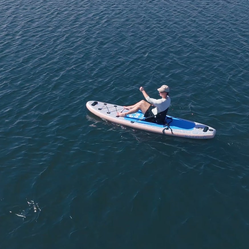 High-angle view of a paddler on the Trekker 10'4", emphasizing its smooth glide on calm water.