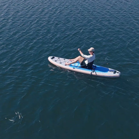 High-angle view of a paddler on the Trekker 10'4", emphasizing its smooth glide on calm water.