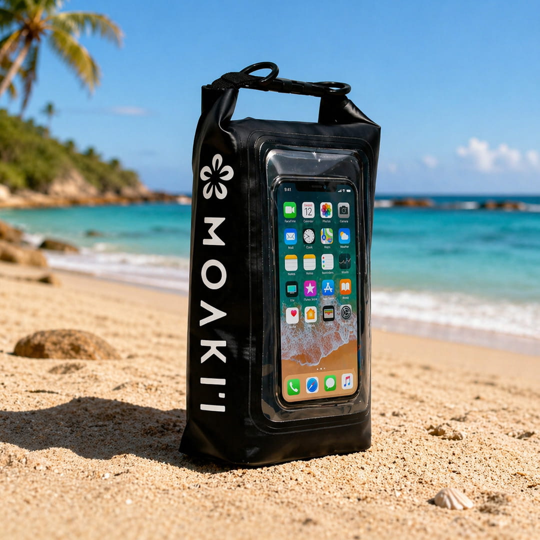 Black phone case with smartphone displaying app icons on a beach with ocean and palm trees in the background