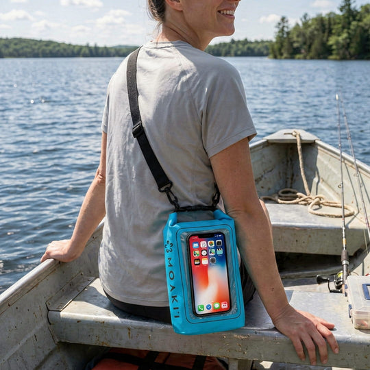Person on a boat with a phone case displaying multiple phone screens.
