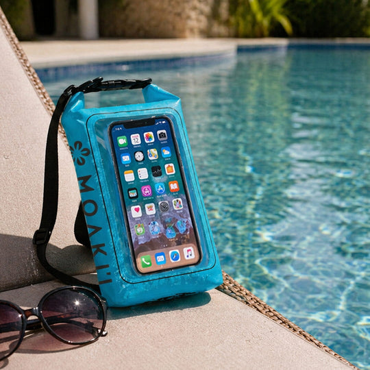 Blue phone case with a smartphone displaying app icons, placed by a poolside.