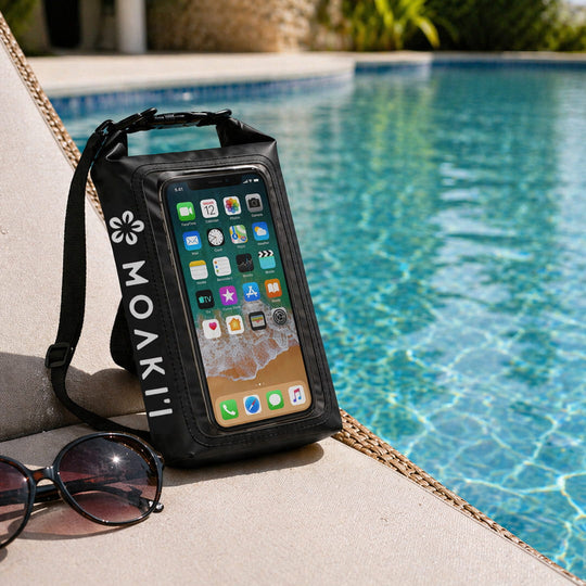 Phone case with smartphone displaying app icons by a poolside