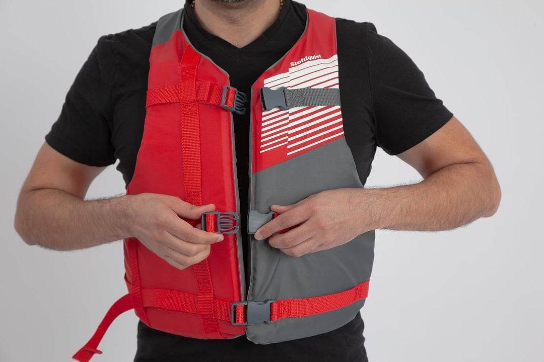 Person wearing a red and gray life vest on a white background