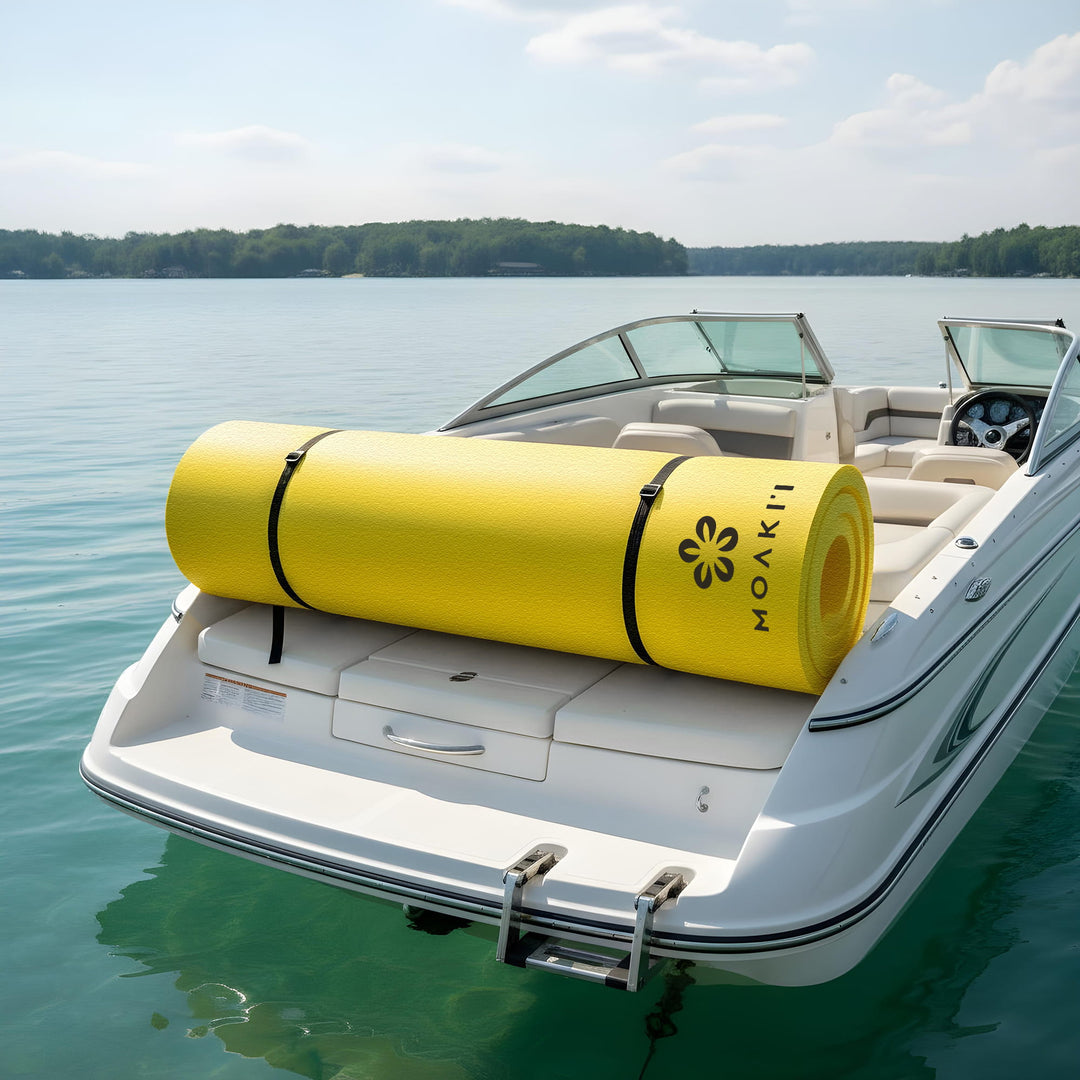 Yellow Moakii mat on a boat in a calm lake with trees in the background