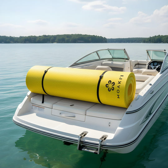 Yellow Moakii mat on a boat in a calm lake with trees in the background
