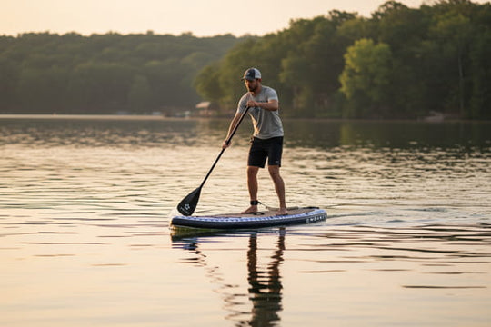 Man paddling the Seeker 11'6" at sunset, perfect for long-distance cruising.