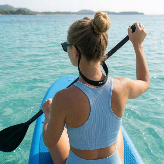 Woman paddling a paddleboard on clear blue water