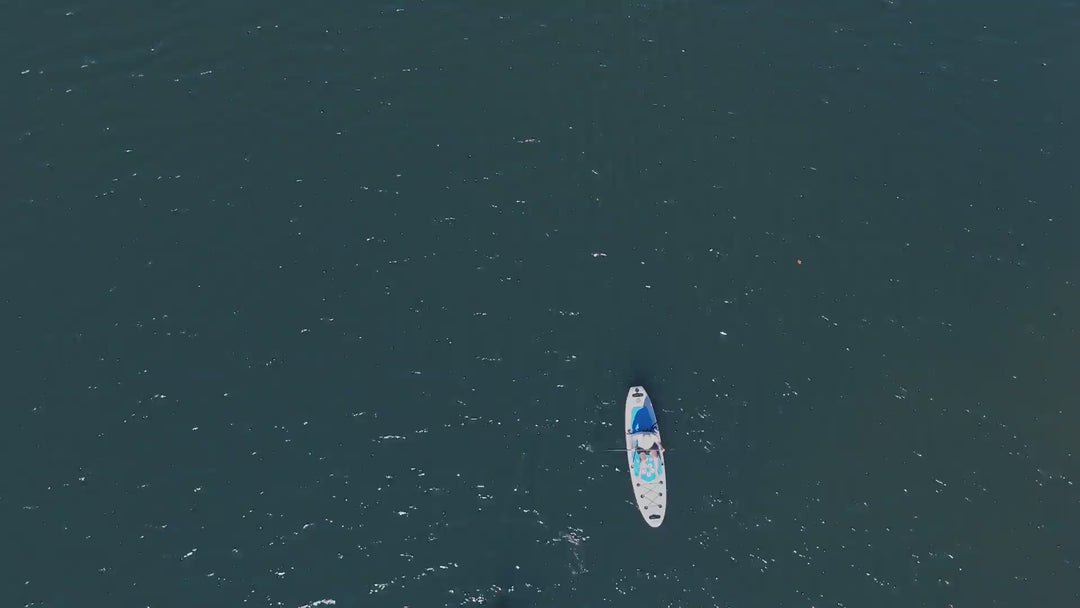 Action video and drone footage showing the Trekker 10'4" paddleboard in motion on clear water.