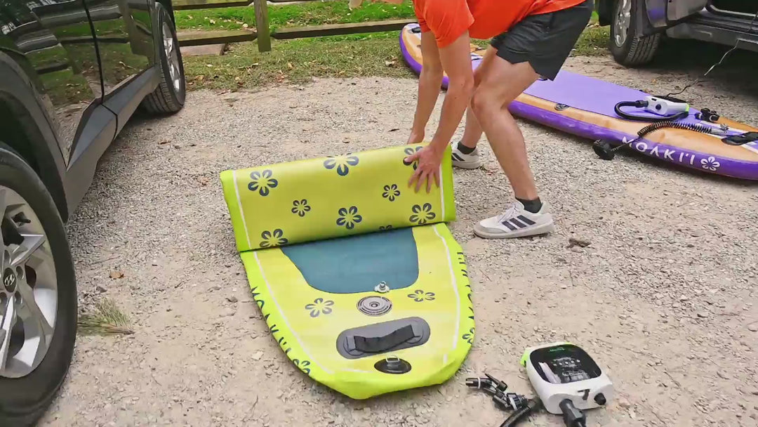 video of a person unrolling inflatable paddleboard about the pump it with air