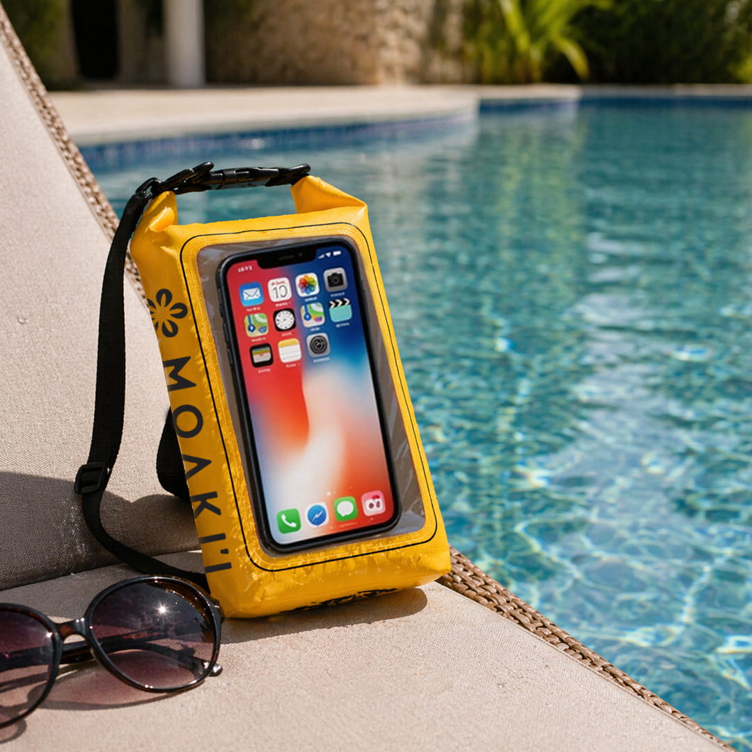 Yellow waterproof phone case with a smartphone displaying app icons, placed by a poolside.